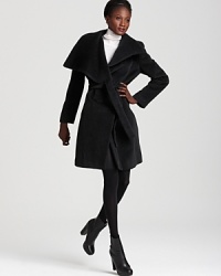This Calvin Klein Premium coat features a grand shawl collar and a fetching belted waist for refined elegance when temperatures fall. This Calvin Klein Premium coat features a grand shawl collar and a fetching belted waist for refined elegance when temperatures fall.