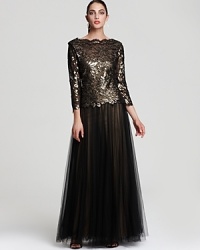 Tadashi Shoji's smart and sophisticated gown sparkles with a floral-patterned, sequined bodice, effortlessly paired with a tulle skirt. Tadashi Shoji's smart and sophisticated gown sparkles with a floral-patterned, sequined bodice, effortlessly paired with a tulle skirt.