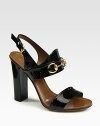 Patent leather high-heel sandal with Gucci horsebit loafer 60th anniversary detail. Self-covered heel, 4 (100mm)Patent leather upperAdjustable slingback strapLeather lining and solePadded insoleMade in Italy