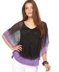 Calvin Klein Jeans adds a bright splash of color to a classic batwing-sleeve top. Try it with white denim for contrast!