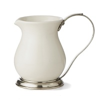 This revolutionary collection combines white ceramic with hand-finished pewter trim, creating a stunning marriage of light and shadow. The entire collection is dishwasher safe. This revolutionary collection combines white ceramic with hand-finished pewter trim, creating a stunning marriage of light and shadow. The entire collection is dishwasher safe.
