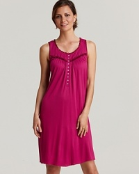 Sweet dreams start wtih this flowy short knit gown with ruffle trim and flower button accents.