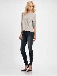 Dark-wash skinnies styled with contrasting leather trim and slight fading. THE FITSkinny fitRise, about 8½Inseam, about 30THE DETAILSButton closureZip flyFour-pocket styleFully linedBody: 92% cotton/7% polyester/1% spandex; Contrast: LeatherDry cleanMade in USAModel shown is 5'10 (177cm) wearing US size 24.