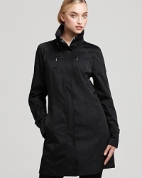 You're in style in this Calvin Klein raincoat. Utility details including a stow-away hood keep the look fresh and silver hardware lends a touch of luxe. Keep important essentials close in the interior pocket and should you need to travel--pack it all up in the included zipper storage bag. You're in style in this Calvin Klein raincoat. Utility details including a stow-away hood keep the look fresh and silver hardware lends a touch of luxe. Keep important essentials close in the interior pocket and should you need to travel--pack it all up in the included zipper storage bag.