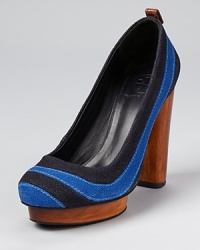 In standout stripes, the Tory Burch Joelle pump makes a colorful statement. A wooden heel and platform finish off the covetable silhouette. In standout stripes, the Tory Burch Joelle pump makes a colorful statement. A wooden heel and platform finish off the covetable silhouette.