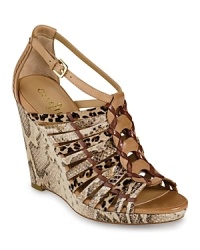 Snake and leopard prints make an exotic combo on these Cole Haan sandals, accented with woven details for a fashion-forward finish. Snake and leopard prints make an exotic combo on these Cole Haan sandals, accented with woven details for a fashion-forward finish.