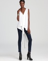 This BCBGMAXAZRIA top takes hemlines to a new low with a dramatic, elongated high/low hem, complimented by a cascading ruffle front.