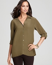 Glimmering accents shine against a silk Eileen Fisher blouse for a luxe take on utilitarian chic. Glimmering accents shine against a silk Eileen Fisher blouse for a luxe take on utilitarian chic.
