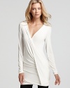 A Donna Karan New York top is draped with a crossover neckline-truly unique for this season of chic.