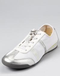 Patent or metallic trim adds a glam touch to these DKNY sneakers, a chic upgrade to the average gym shoe.