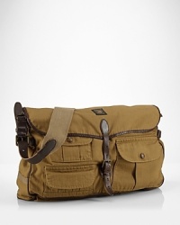 Drawing inspiration from the iconic Mohawk jacket, a rugged messenger bag is rendered in cotton herringbone with ample pockets and leather trim for a classic finish. Drawing inspiration from the iconic Mohawk jacket, a rugged messenger bag is rendered in cotton herringbone with ample pockets and leather trim for a classic finish.