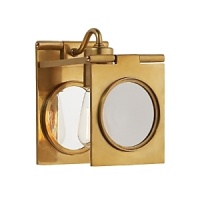 The contemporary design of this Ralph Lauren sconce reflects light off glass and warm brass. The contemporary design of this Ralph Lauren sconce reflects light off glass and warm brass.