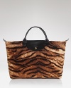 In a wild tiger print, Longchamp's velvet cotton handbag channels safari-chic.