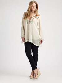 Featuring incredible embroidered details, this airy tunic offers a relaxed fit that you will love. Self-tie necklineLong sleevesStunning embroidery on front and backBack yokePull-on styleAbout 34 from shoulder to hemRayonMachine washImported Featuring incredible embroidered details, this airy tunic offers a relaxed fit that you will love. Self-tie necklineLong sleevesStunning embroidery on front and backBack yokePull-on styleAbout 34 from shoulder to hemRayonMachine washImported