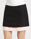 A contrasting layer peeks out from underneath this ultra-short, woven mini skirt.Side zipperSlash pocketsLayered-look hemAbout 15 from natural waistCottonDry cleanImportedModel shown is 5'10 (177cm) wearing US size 4. 