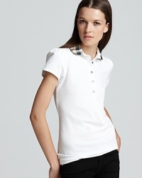 Ruched detail on the collar and puffed sleeves lend a feminine touch to the classic polo. Ruched detail on the collar and puffed sleeves lend a feminine touch to the classic polo.