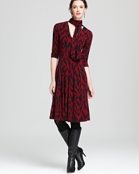 With a nod to the '70s, this Anne Klein dress masters timeless elegance with a retro ikat print and chic tie neckline. Style with well-heeled boots for everyday glamour. With a nod to the '70s, this Anne Klein dress masters timeless elegance with a retro ikat print and chic tie neckline. Style with well-heeled boots for everyday glamour.
