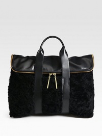 A mix of smooth leather and luxurious shearling come together in an elegant and distinctive style, perfectly sized for all your essentials.Double top handles, 4 dropFold-over zip closureOne inside zip pocketFully lined16¼W X 12½H X 6¾DImported