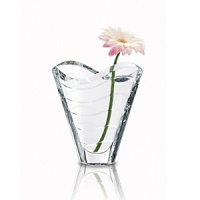 Sleek, sinuous form mimics the movement of water. An arresting piece on its own, it also offers an organic frame for a floral arrangement. 8 7/8H. Sleek, sinuous form mimics the movement of water. An arresting piece on its own, it also offers an organic frame for a floral arrangement. 8 7/8H.