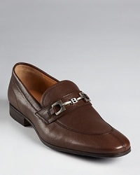 Treat your feet to true luxury with these refined leather loafers from Bally, crafted in exquisite leather with modern details like the geometric logo buckle in matte silver-tone that crosses the tongue. Treat your feet to true luxury with these refined leather loafers from Bally, crafted in exquisite leather with modern details like the geometric logo buckle in matte silver-tone that crosses the tongue.