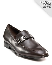 Sleek and stylish slip-on dress shoes with leather strap and buckle detail at top. Round toe. Gancini insignia etched on buckle and heel. Leather sole with slightly stacked heel. Sleek and stylish slip-on dress shoes with leather strap and buckle detail at top. Round toe. Gancini insignia etched on buckle and heel. Leather sole with slightly stacked heel.