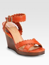 A chic snake-embossed leather style with scalloped trim, stacked wedge heel and sturdy wrap-around ankle strap. Stacked wedge, 4 (100mm)Stacked platform, ¾ (20mm)Compares to a 3¼ heel (80mm)Snake-embossed leather upperAdjustable ankle strapLeather lining and solePadded insoleImportedOUR FIT MODEL RECOMMENDS ordering one size up as this style runs small. A chic snake-embossed leather style with scalloped trim, stacked wedge heel and sturdy wrap-around ankle strap. Stacked wedge, 4 (100mm)Stacked platform, ¾ (20mm)Compares to a 3¼ heel (80mm)Snake-embossed leather upperAdjustable ankle strapLeather lining and solePadded insoleImportedOUR FIT MODEL RECOMMENDS ordering one size up as this style runs small.