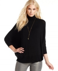 Kick back in this poncho-style top from Calvin Klein Jeans. It's the perfect silhouette with the season's skinny jeans. Kick back in this poncho-style top from Calvin Klein Jeans. It's the perfect silhouette with the season's skinny jeans.