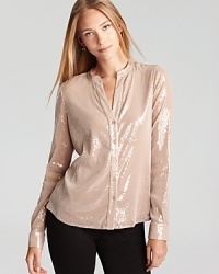 Demure yet dramatic, this Calvin Klein blouse shimmers with a subtle sequin finish for a 24-7 standout look. Team with jeans for a luxe approach to laidback style, or slip the statement piece over trousers for workweek chic. Demure yet dramatic, this Calvin Klein blouse shimmers with a subtle sequin finish for a 24-7 standout look. Team with jeans for a luxe approach to laidback style, or slip the statement piece over trousers for workweek chic.