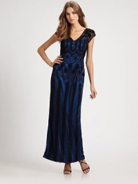 A stunning vintage-style gown with bold geometric beading, swirling embroidery and a sweeping back cutout.V-neckCap sleevesConcealed side zip closureBack cutoutAllover embroidery with beadingAbout 44 from natural waistFully linedNylonDry cleanImportedModel shown is 5'10 (177cm) wearing US size 4. A stunning vintage-style gown with bold geometric beading, swirling embroidery and a sweeping back cutout.V-neckCap sleevesConcealed side zip closureBack cutoutAllover embroidery with beadingAbout 44 from natural waistFully linedNylonDry cleanImportedModel shown is 5'10 (177cm) wearing US size 4.