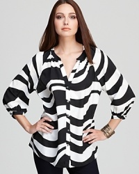 A graphic whirl of zebra print inspires an Isaac Mizrahi Jeans top, proving that black and white make a bold style statement. A graphic whirl of zebra print inspires an Isaac Mizrahi Jeans top, proving that black and white make a bold style statement.