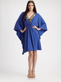 A silky matte jersey knit has capelike batwing sleeves and a bold hammered metal appliquéd necklace.V neckline with hammered metallic oval discsGathering and smocking at center front Three-quarter wide, draped batwing sleevesPullover stylingAbout 37 from shoulder to hem24% polyester/6% spandexDry cleanImported Model shown is 5'9½ (176cm) wearing US size Small. A silky matte jersey knit has capelike batwing sleeves and a bold hammered metal appliquéd necklace.V neckline with hammered metallic oval discsGathering and smocking at center front Three-quarter wide, draped batwing sleevesPullover stylingAbout 37 from shoulder to hem24% polyester/6% spandexDry cleanImported Model shown is 5'9½ (176cm) wearing US size Small.