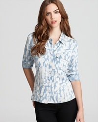 Classic leopard acquires a winter white twist on this GUESS shirt that features a collared neckline and on-trend high/low hem. Classic leopard acquires a winter white twist on this GUESS shirt that features a collared neckline and on-trend high/low hem.