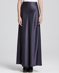 A flowing Vince maxi skirt flaunts a luxe metallic shine, creating an elegant evening look perfect for cocktails or a chic al fresco engagement. A flowing Vince maxi skirt flaunts a luxe metallic shine, creating an elegant evening look perfect for cocktails or a chic al fresco engagement.