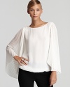 Brimming with ethereal elegance, this VINCE CAMUTO top makes a dramatic entrance with generously pleated sleeves. Slip it on and prepare stand out.