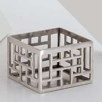 Dozens of square and rectangular cutouts give this wine coaster from Natori a modern, dimensional look. Dozens of square and rectangular cutouts give this wine coaster from Natori a modern, dimensional look.