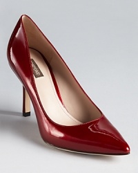 A classic pair of Joan & David pumps shines in glossy patent leather.