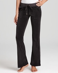 Snap-patch back pockets lend a utility-inspired feel to Juicy Couture's signature velour lounge pants. Snap-patch back pockets lend a utility-inspired feel to Juicy Couture's signature velour lounge pants.