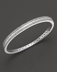 Round and baguette, white gold diamond bangle in 14 kt. white gold. Round and baguette, white gold diamond bangle in 14 kt. white gold.