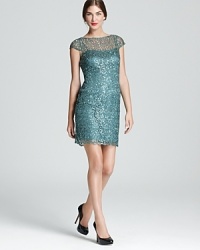 A web-like fabric is adorned with shimmering sequins on Kay Unger's sparkling cap-sleeved creation. A web-like fabric is adorned with shimmering sequins on Kay Unger's sparkling cap-sleeved creation.