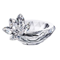 An elegant clear crystal faceted bowl flaunts a sparkling waterlily on the rim. This decorative creation lends a touch of grace and an element of light to your home. An elegant clear crystal faceted bowl flaunts a sparkling waterlily on the rim. This decorative creation lends a touch of grace and an element of light to your home.