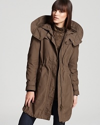 A modern mastery, this Burberry Brit coat features an anorak-style exterior equipped with a detachable quilted interior. Worn together or separately, the styles ensure a favorable fashion forecast, even on the chilliest of days. A modern mastery, this Burberry Brit coat features an anorak-style exterior equipped with a detachable quilted interior. Worn together or separately, the styles ensure a favorable fashion forecast, even on the chilliest of days.