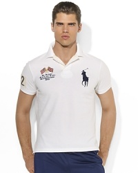 A trim-fitting polo shirt in breathable cotton mesh is finished with bold country details and Ralph Lauren's signature Big Pony. A trim-fitting polo shirt in breathable cotton mesh is finished with bold country details and Ralph Lauren's signature Big Pony.
