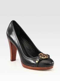 A goldtone signature emblem is at the center of this leather wardrobe staple. Wooden stacked heel, 4 (100mm)Wooden platform, ½ (15mm)Compares to a 3½ heel (90mm)Leather upperLeather liningRubber solePadded insoleImported A goldtone signature emblem is at the center of this leather wardrobe staple. Wooden stacked heel, 4 (100mm)Wooden platform, ½ (15mm)Compares to a 3½ heel (90mm)Leather upperLeather liningRubber solePadded insoleImported