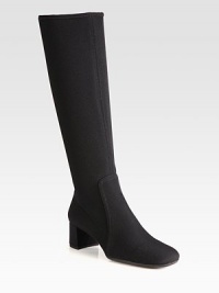 A tall silhouette of stretch fabric with a square toe and block heel. Self-covered heel, 1¾ (45mm)Shaft, 15Leg circumference, 13½Stretch-fabric upperSide zipRubber solePadded insoleImported