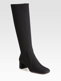 A tall silhouette of stretch fabric with a square toe and block heel. Self-covered heel, 1¾ (45mm)Shaft, 15Leg circumference, 13½Stretch-fabric upperSide zipRubber solePadded insoleImported A tall silhouette of stretch fabric with a square toe and block heel. Self-covered heel, 1¾ (45mm)Shaft, 15Leg circumference, 13½Stretch-fabric upperSide zipRubber solePadded insoleImported