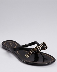 IVANKA TRUMP takes a luxe approach to a laid-back jelly sandal, dressing up the playful silhouette with a feminine bow and edgy studded details. IVANKA TRUMP takes a luxe approach to a laid-back jelly sandal, dressing up the playful silhouette with a feminine bow and edgy studded details.