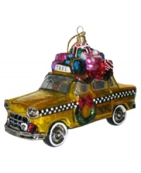 Trade in your sleigh for a classic New York City cab. Piled with presents and decked out with a wreath, this glass taxi ornament recalls the city's most magical time of year. Trade in your sleigh for a classic New York City cab. Piled with presents and decked out with a wreath, this glass taxi ornament recalls the city's most magical time of year.