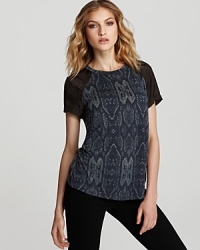 Elevate your t-shirt collection with this Rebecca Minkoff burnout tee patterned in python. Elevate your t-shirt collection with this Rebecca Minkoff burnout tee patterned in python.