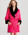 Dash your at-home look with drama in Betsey Johnson's playful velour robe with plush faux mink details.