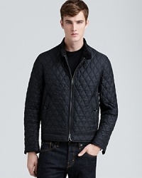 The allover diamond quilting of this classic nylon bomber jacket reveals military inspiration and cunning craftsmanship from Burberry Brit, a thoroughly masculine design that has wear-anywhere versatility. The allover diamond quilting of this classic nylon bomber jacket reveals military inspiration and cunning craftsmanship from Burberry Brit, a thoroughly masculine design that has wear-anywhere versatility.